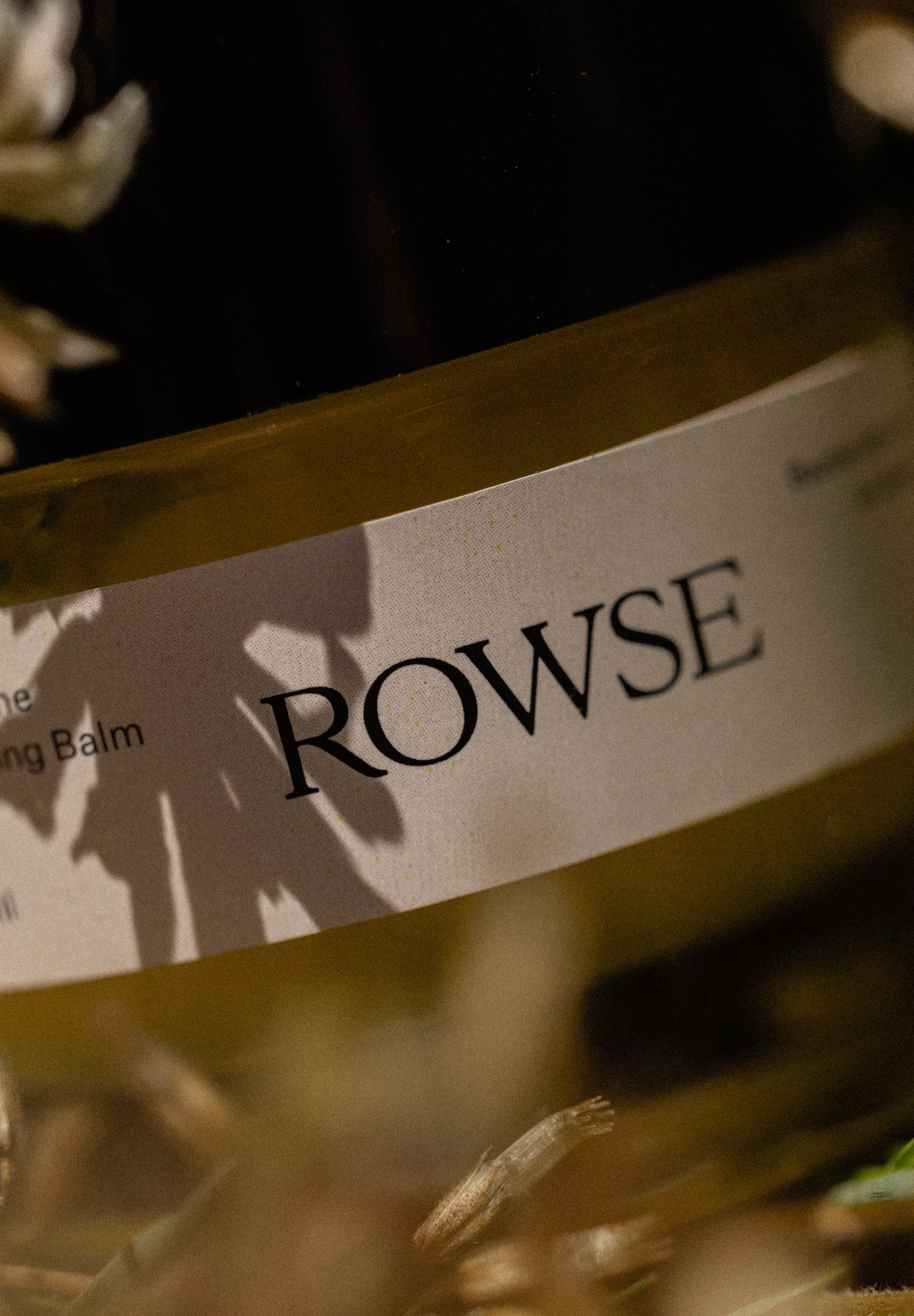 Close-up of a Rowse product label with blurred natural background